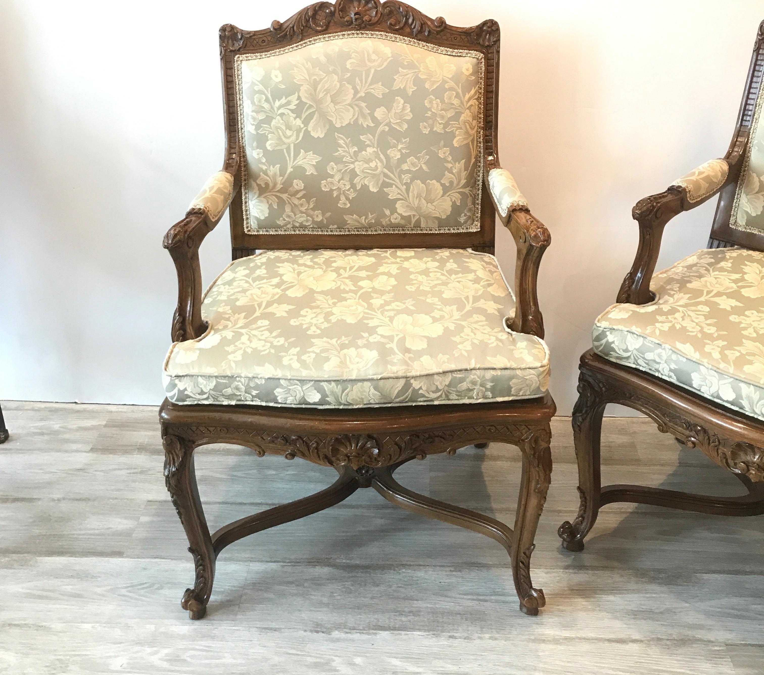 A pair of hand carve walnut framed open armchairs with new fabric. The frames with hand carved detailing all-over with new light sage damask fabric. Beautiful warm dark wood with clean smooth finish..
Measures: 25 wide, 38 high 24 deep 20 seat...