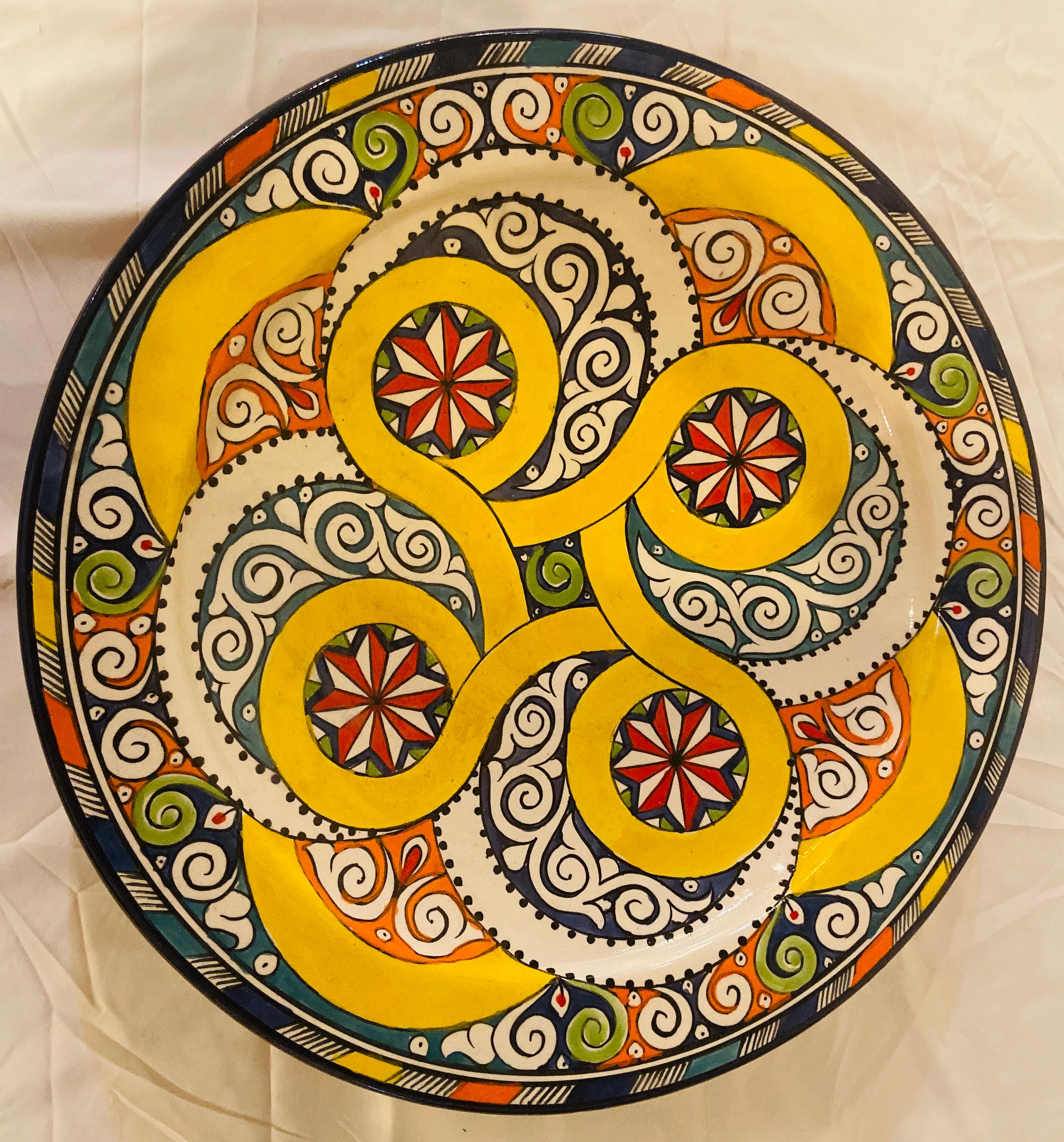 With a delightful floral and arabesque design hand painted in multiple colors in blue, yellow and red, these gorgeous, large-size ceramic dinner plate possesses a truly exotic look. Handcrafted in the bustling workshops of master artisans in the