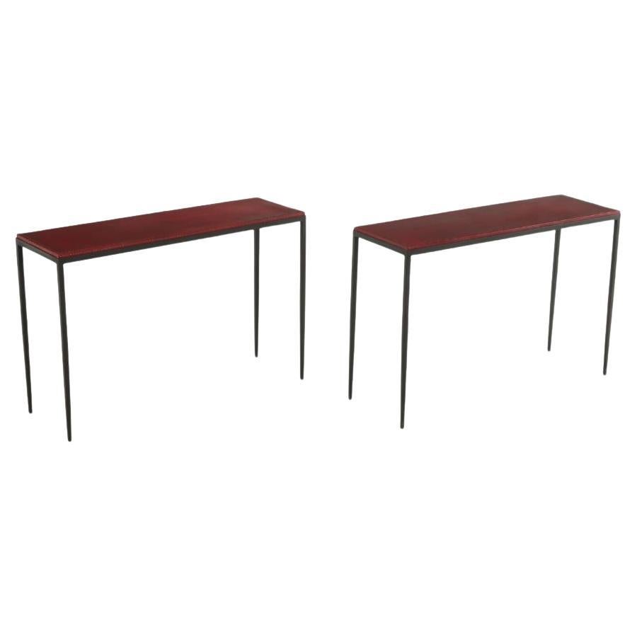 A pair of hand stiched iron and leather console tables