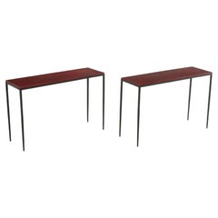 A pair of hand stiched iron and leather console tables