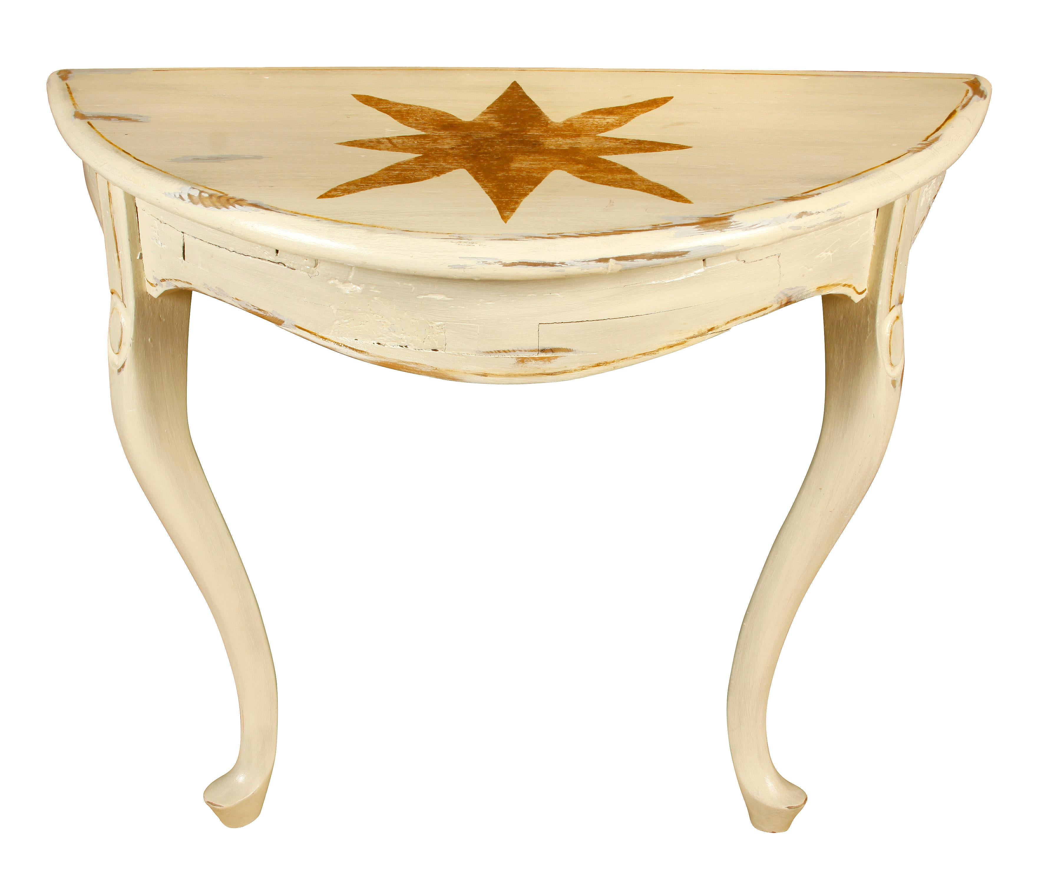 A pair of hand painted star cream demilune tables, wall mounted with cabriole legs.
