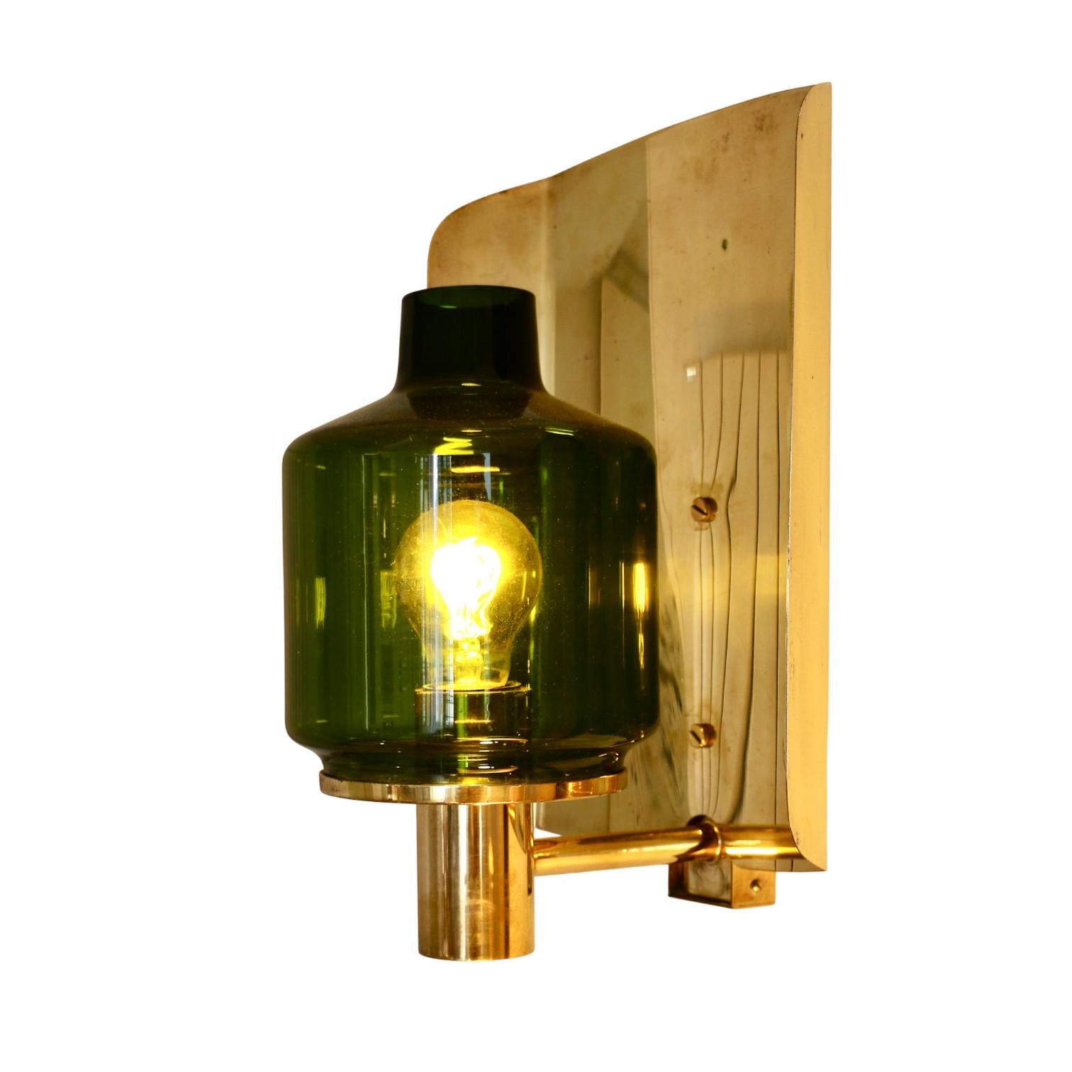 A pair of Hans Agne Jakobsson sconces, model 222. Solid brass structure and green glass diffuser. Sweden, 60s.