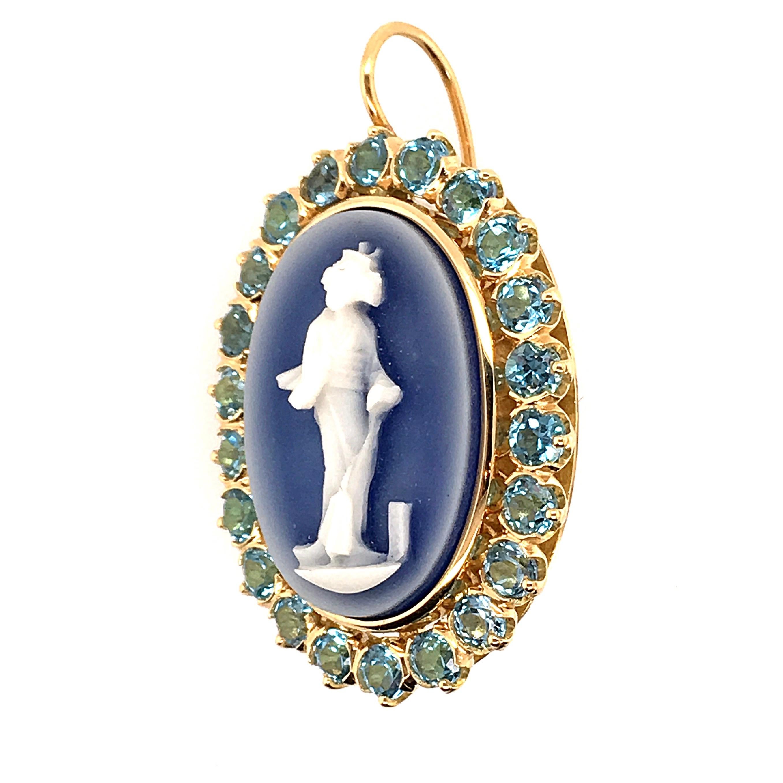 A pair of 18 karat yellow gold,  cameo and blue topaz earrings. Designed by Marcella Ciceri. Each set with a green or blue hardstone cameo, depicting a classical Asian figure, circa 1930, within a circular blue topaz surround, from a wire. Length is