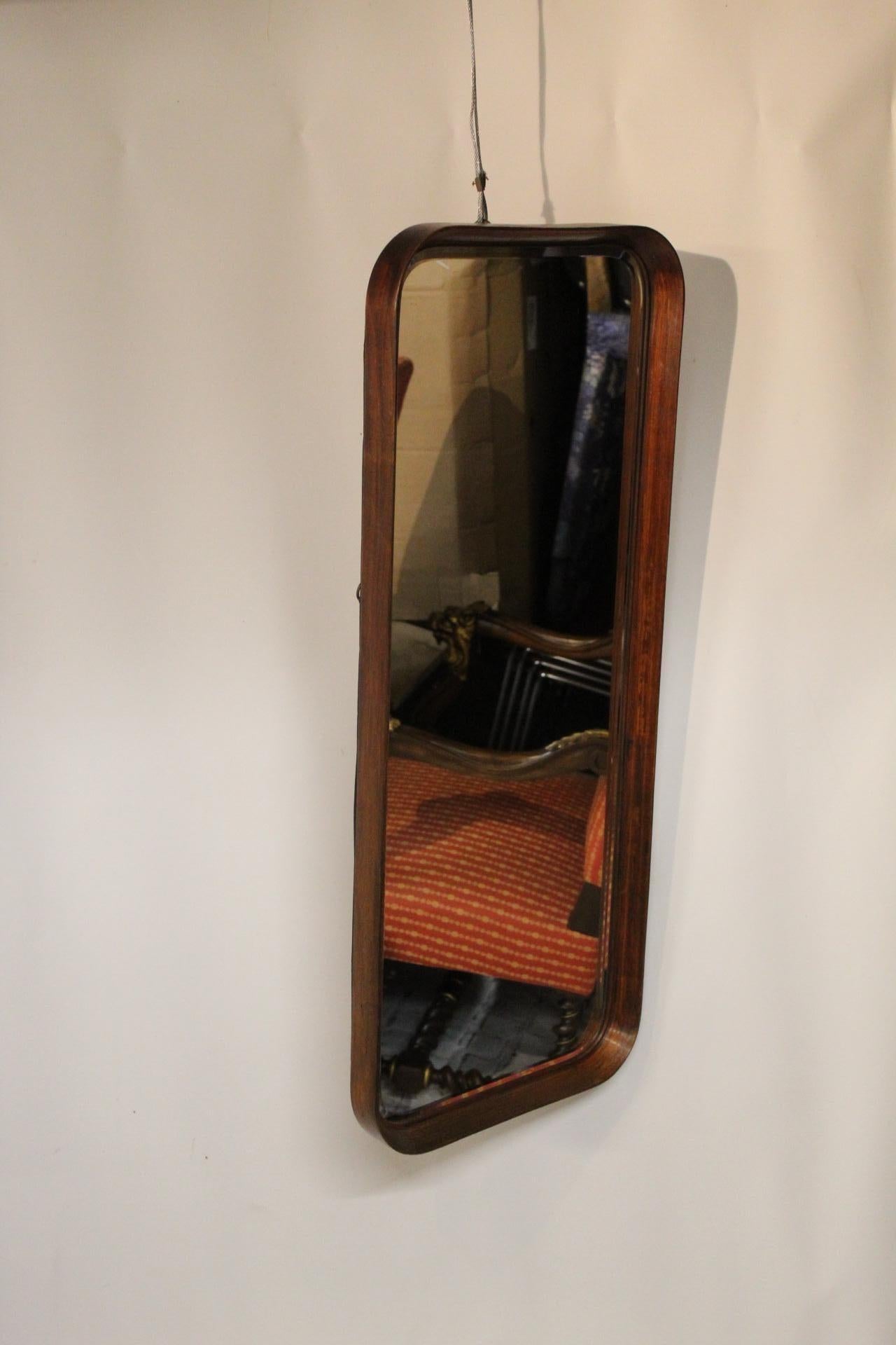 A pair of midcentury wall mirrors with styled concave molded fames, the high quality glass finelly bevelled, nice easy sizes and can be hung together in portrait and landscape.