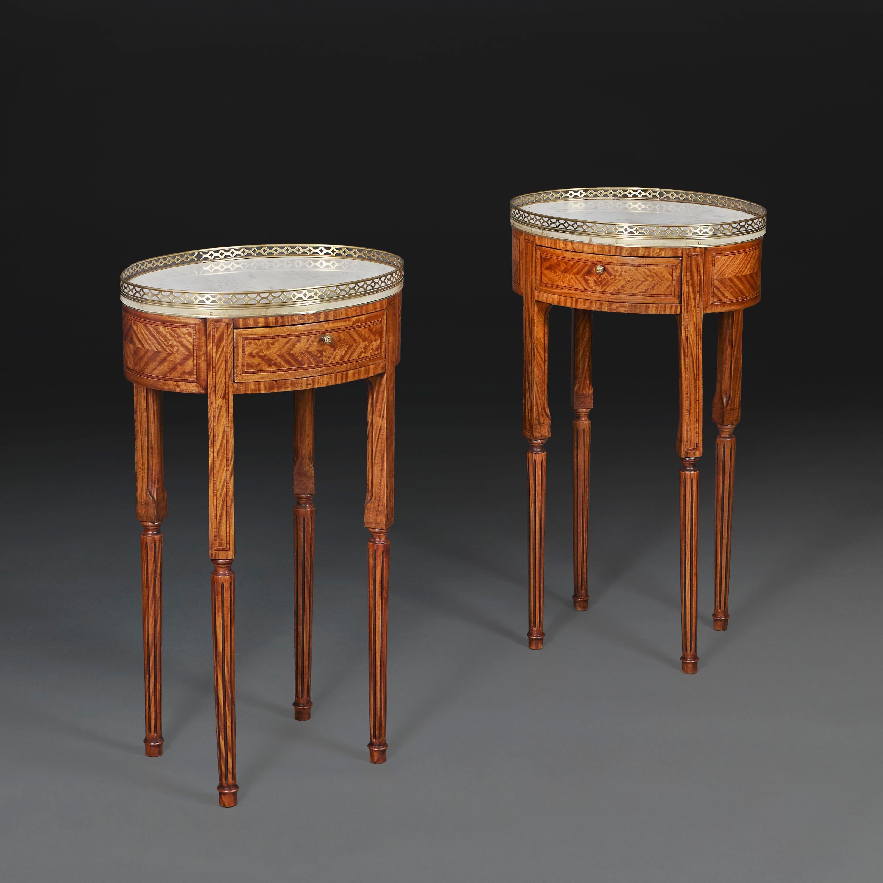 France, circa 1850

A fine pair of nineteenth century Harewood and rosewood occasional tables of oval form, in Louis XVI style, with Carrara marble inset and brass galleried tops, with single drawer to the frieze and supported on tapering