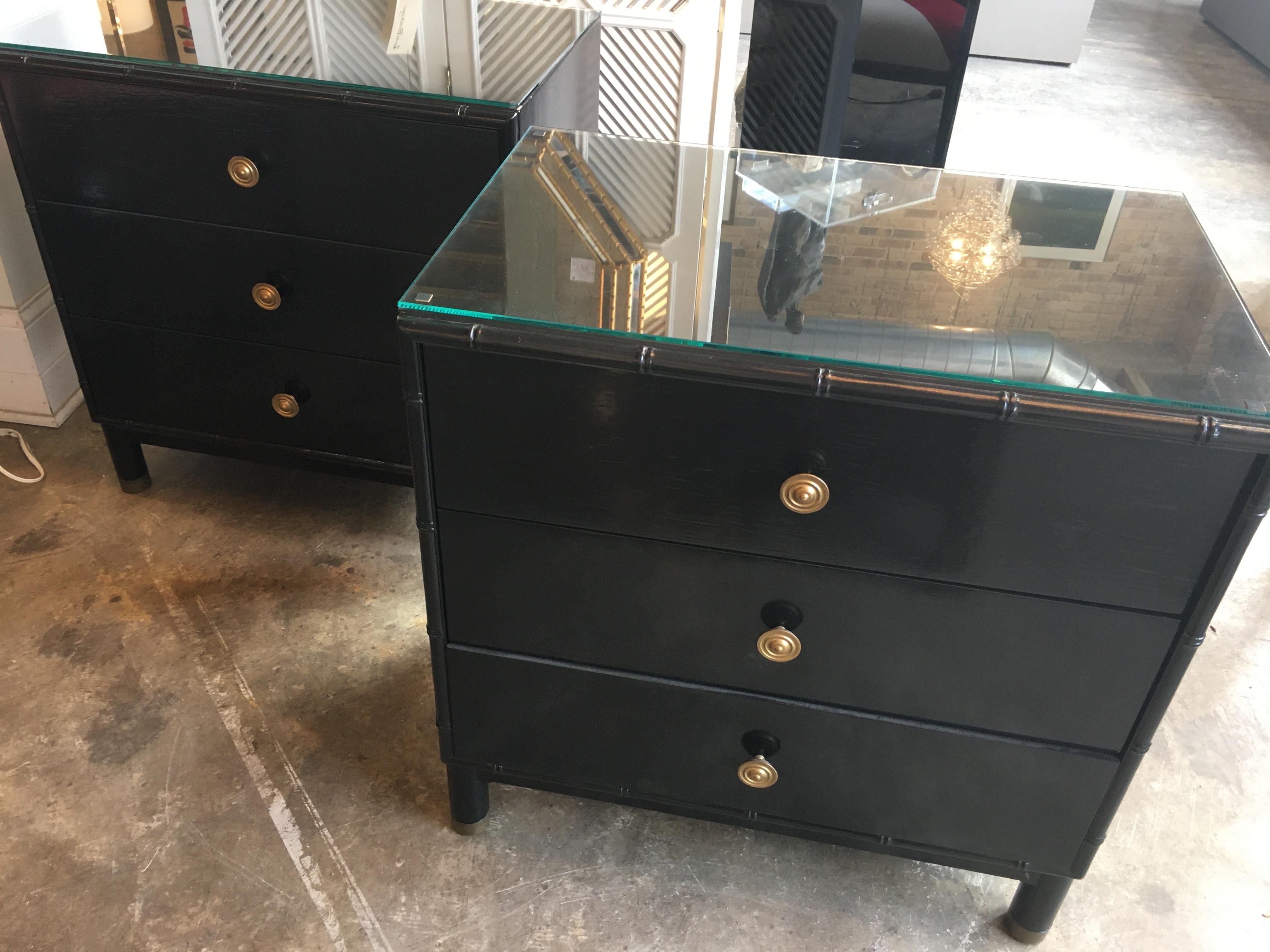 A pair of Henredon black 3-drawer chests with a bamboo motif and brass pulls.