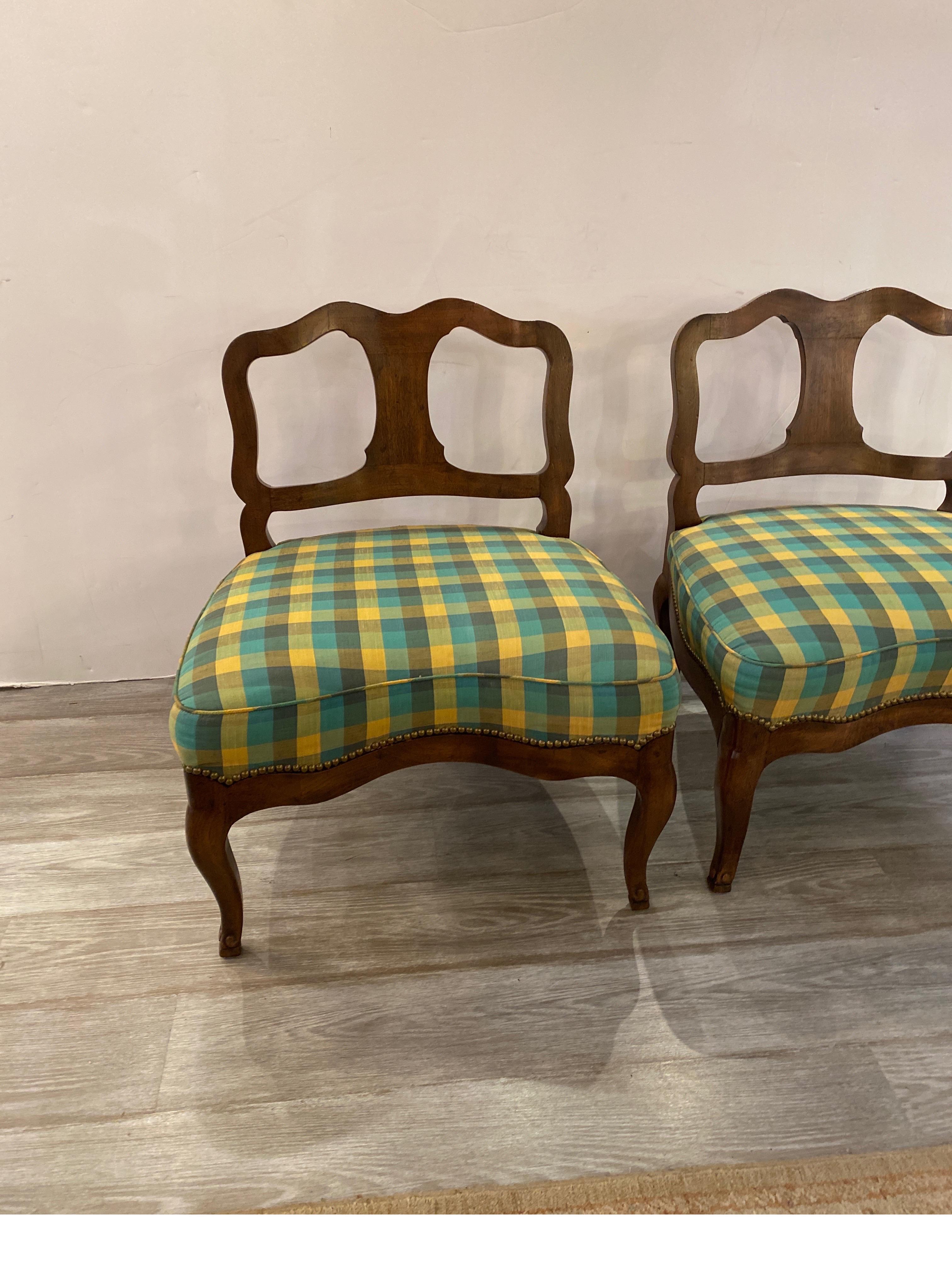 A chic pair of mid century Hollywood regency occasional chairs by Henredon.  The solid wood frames with green and blue upholstered seat with concaved fronts.  The eight way hand tied springs with kiln dried hardwood frames with original tag dated