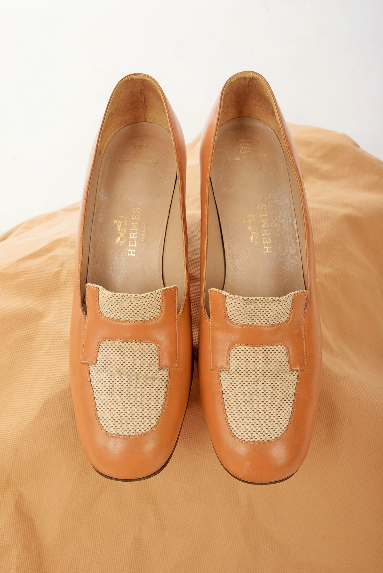 Circa 2000

Paris France

A beautiful pair of heels (7 cm) or pumps in camel leather and cotton canvas with the famous H of Hermes on the vamp. Numbered 712183 in 39 F Made in France. Small scratch on a shoe at the edge of the sole with the patina