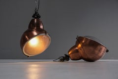 A pair of impressive, French factory lights made of copper and glas