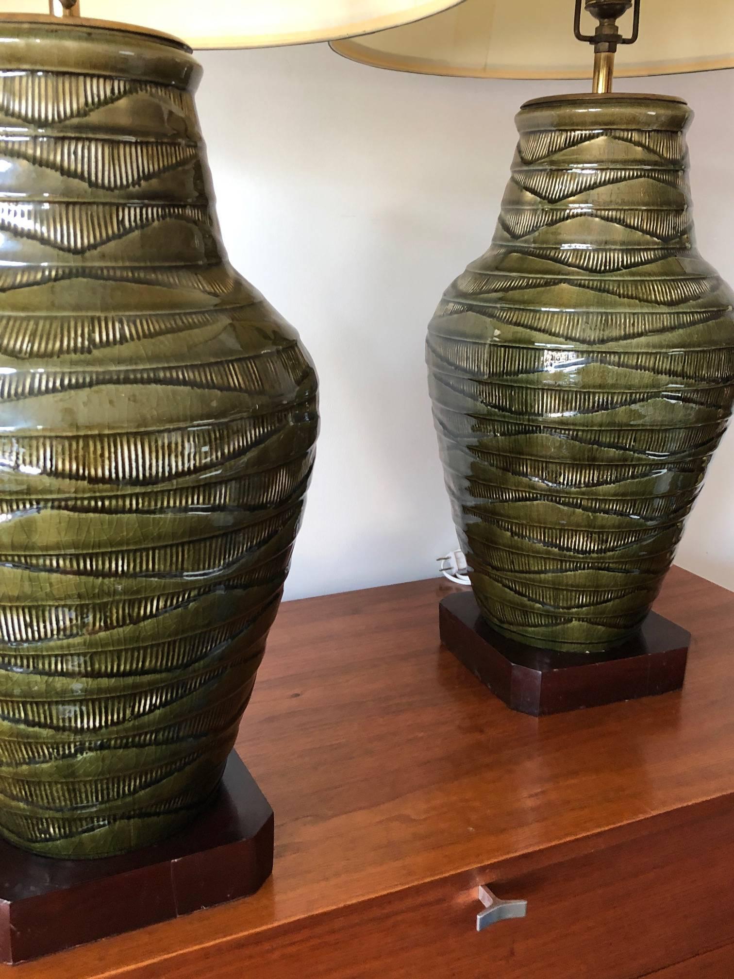 A pair of large-scale green Thai Celadon-marked  lamps. Ceramic/porcelain bases measure approx. 18