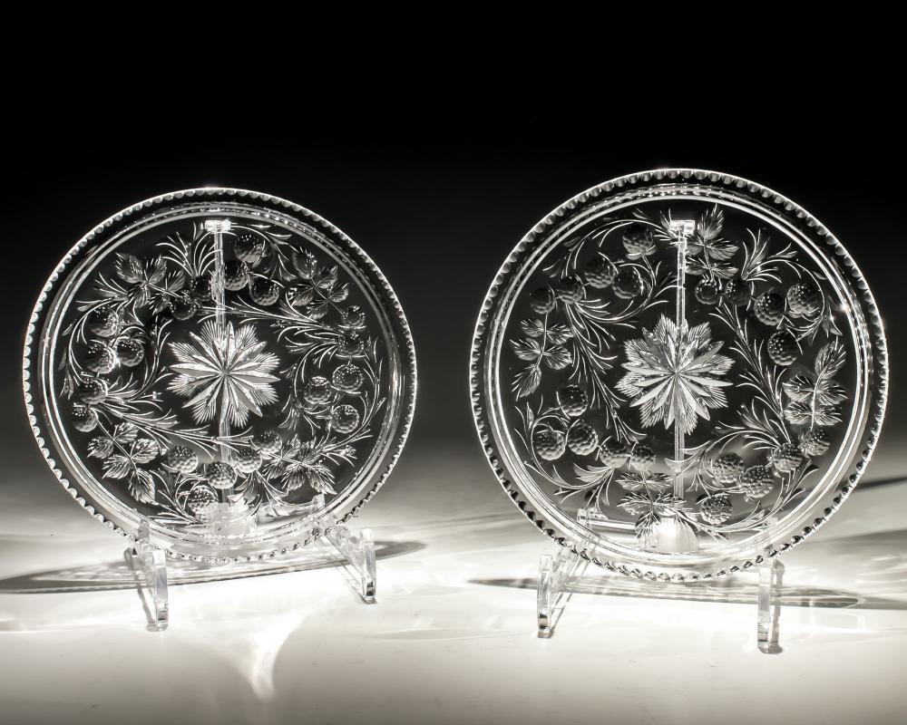A pair of glass plates intaglio engraved with fruiting vines with a star cut centre.