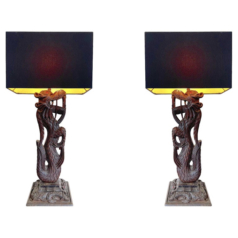 Pair of Intricately Carved Burmese Dragon Lamps Each Mounted on Carved