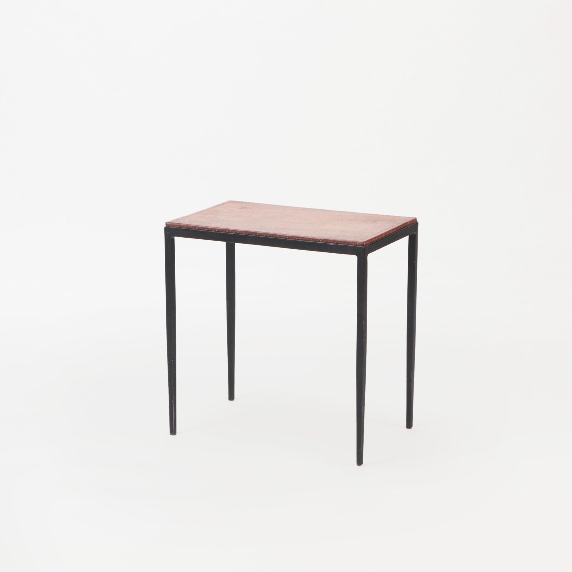 A pair of iron and leather tops small console tables or end tables. Contemporary. In the manner of Jean-Michel Frank.