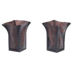 A pair of iron and leather waste baskets, contemporary.