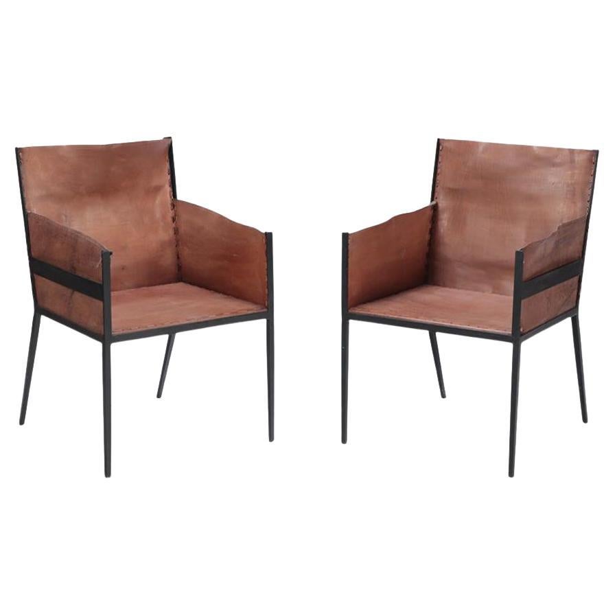 A Pair of Iron and Tailored Leather Armchairs. im Angebot