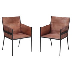 A Pair of Iron and Tailored Leather Armchairs.
