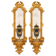 A pair of Italian 17th century Baroque period Giltwood mirrored wall brackets.