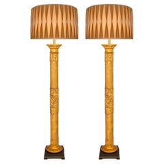 A pair of Italian 18th century Baroque st Giltwood & patinated wood floor lamps