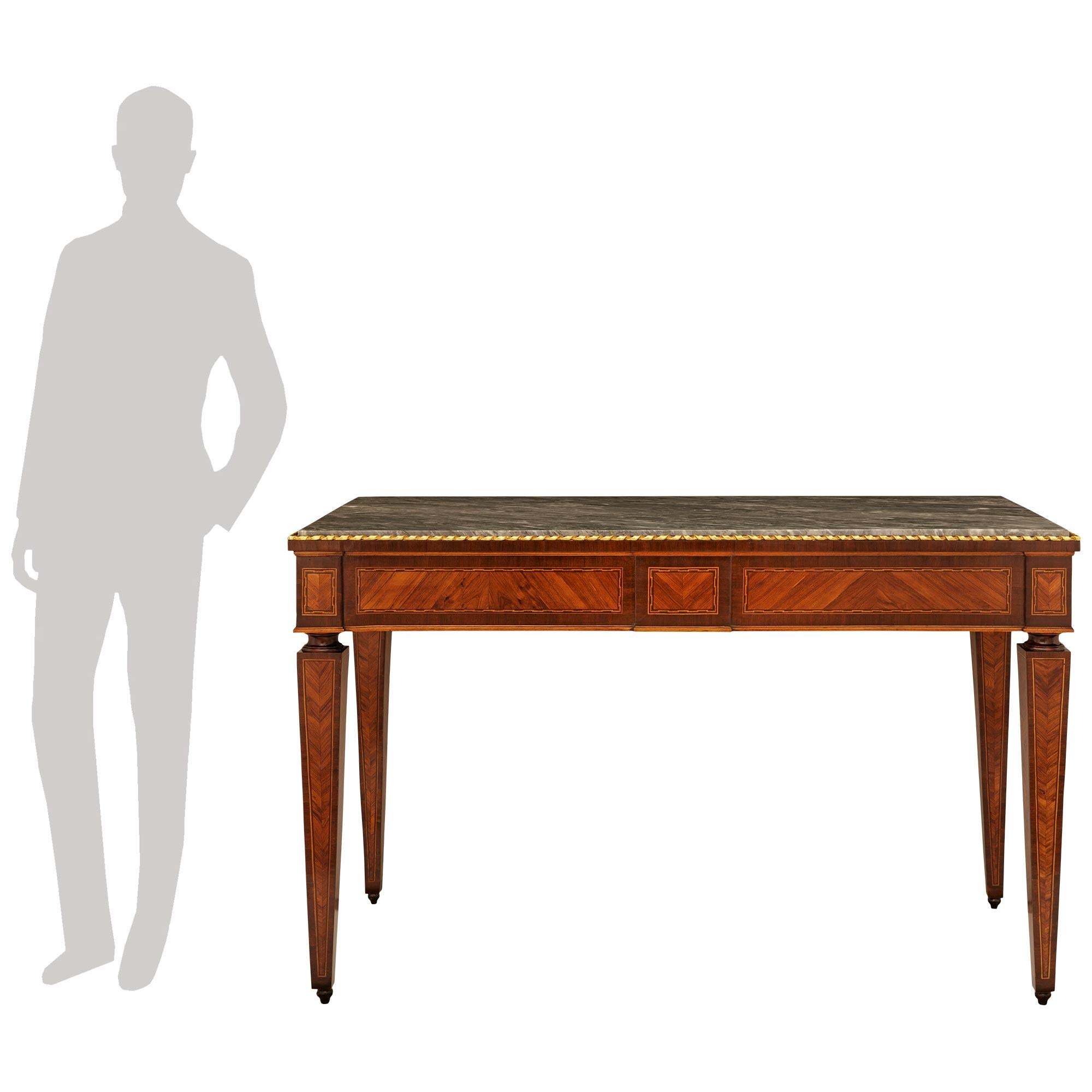 A lovely and most elegant pair of Italian 18th century Louis XVI Period Kingwood, Tulipwood, Giltwood and Gris St. Anne marble consoles. Each stunning freestanding console is raised by Kingwood topie shaped feet below square tapered legs with