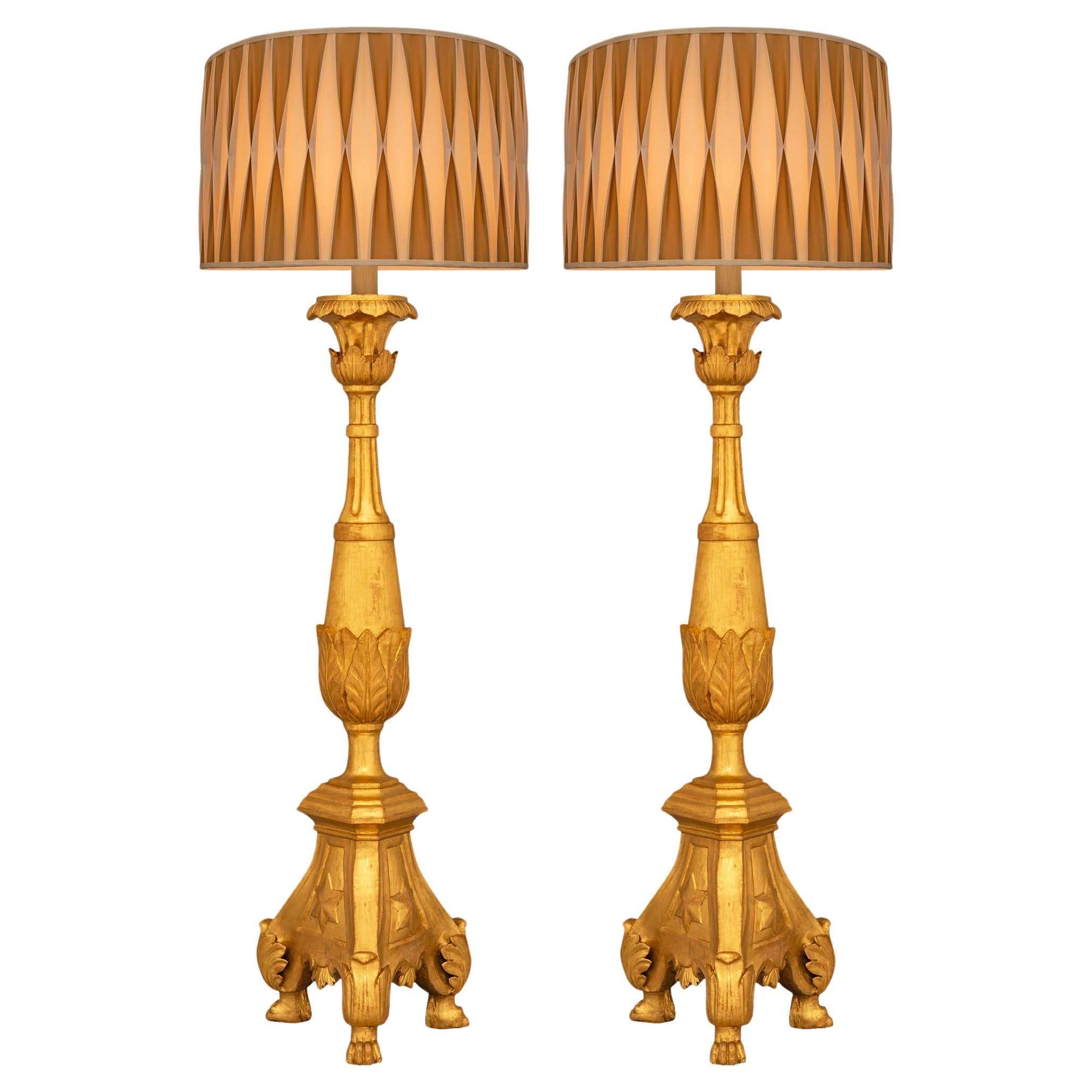 A pair of Italian 18th century Louis XVI st. Giltwood floor lamps
