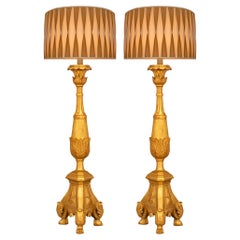 A pair of Italian 18th century Louis XVI st. Giltwood floor lamps