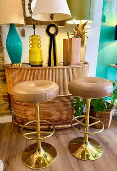 A pair of Italian 1970s gilt metal and leather bar stools