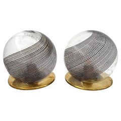 A pair of Italian 1970s smoked Murano glass swirl ball lamps with brass bases