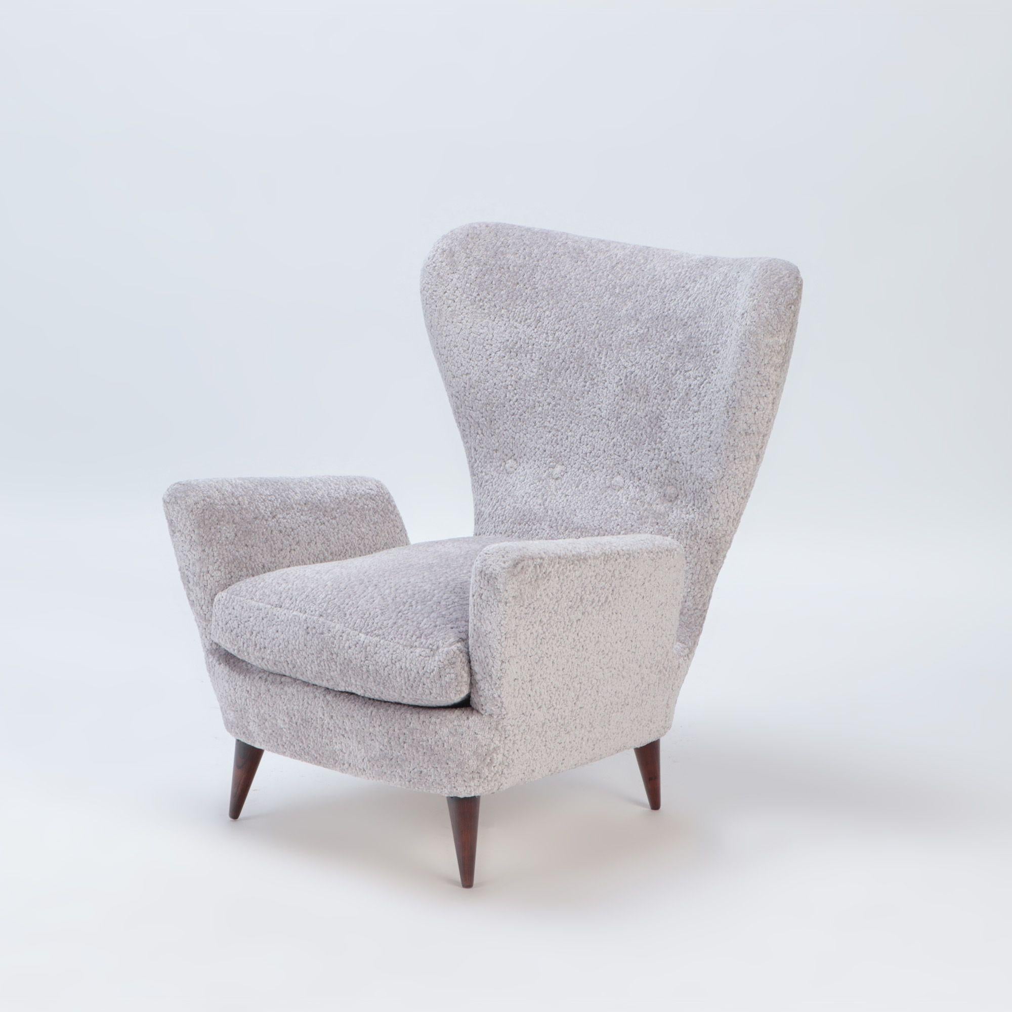 A pair of wingback restored Italian armchairs by Paolo Buffa, C 1950.