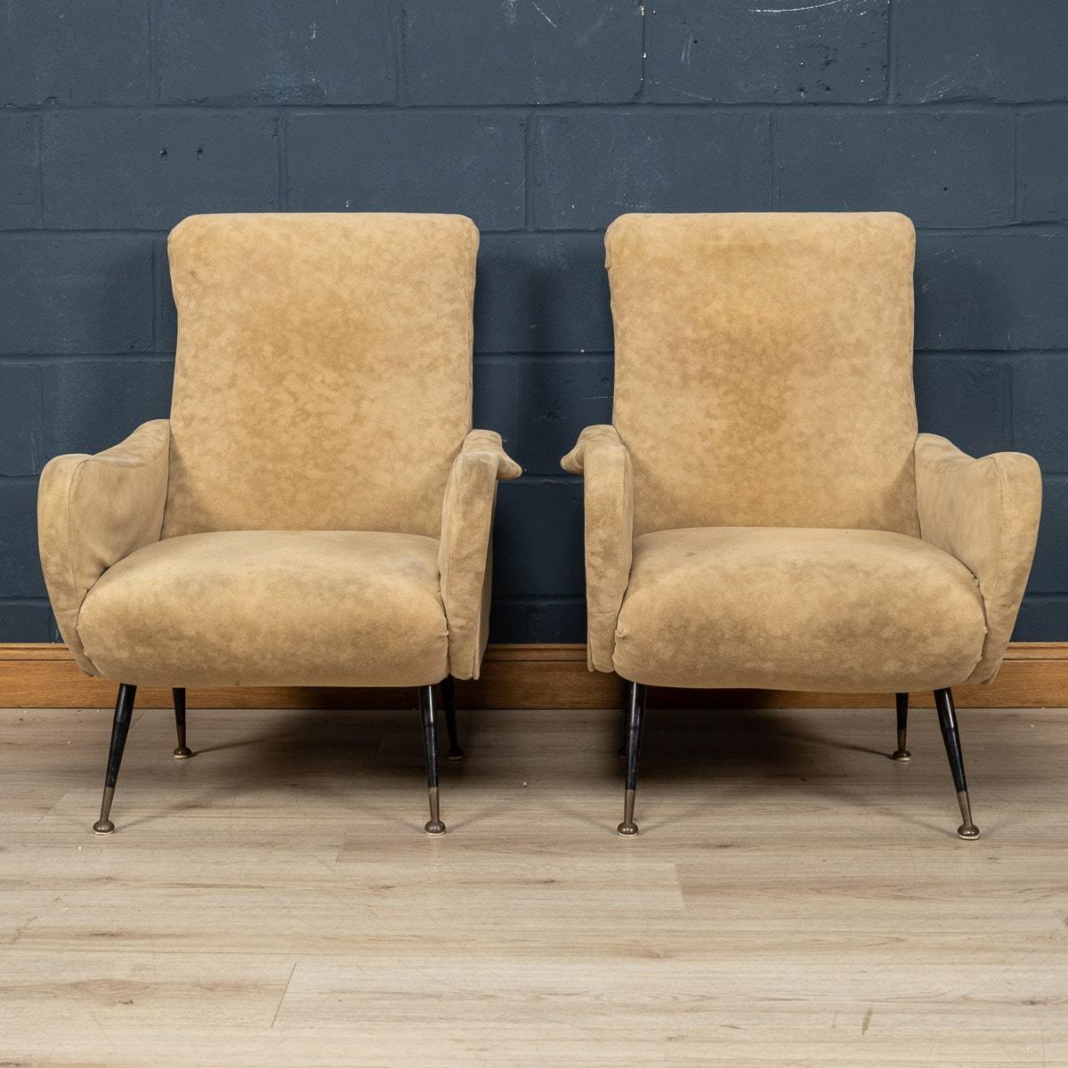 A lovely pair of armchairs made in Italy in the middle part of the 20th century. These armchairs have been upholstered in a sumptuous beige chamois leather, the striking mid century design with needle legs fitting so well in any modern or vintage