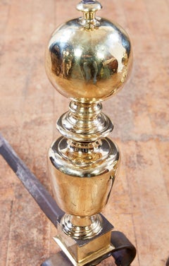 A Pair of Italian Baroque Brass and Iron Andirons