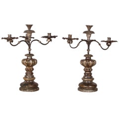 A pair of Italian Baroque style silver gilt pricket sticks