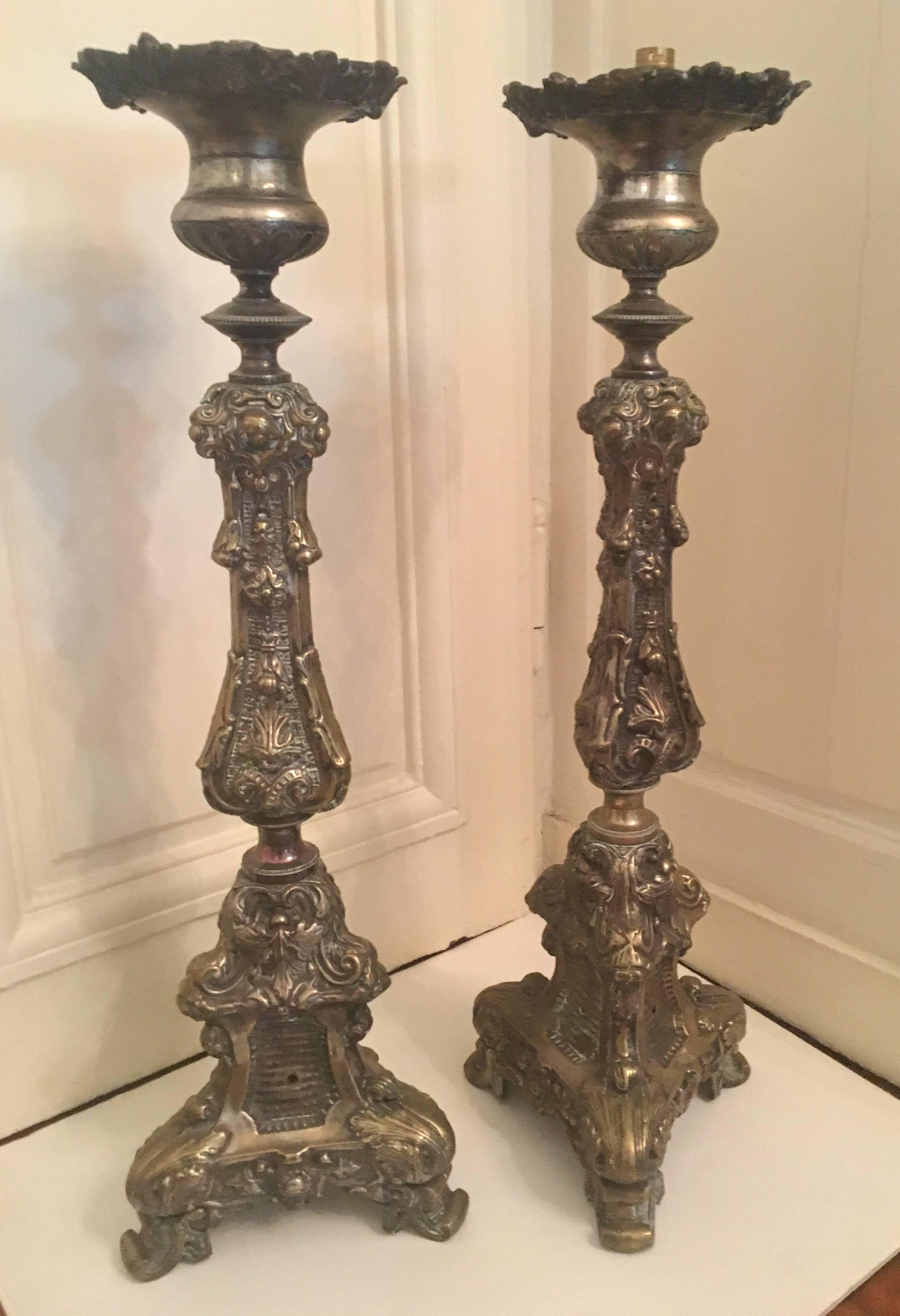 A pair of Italian Baroque style tall altar candlesticks with a 