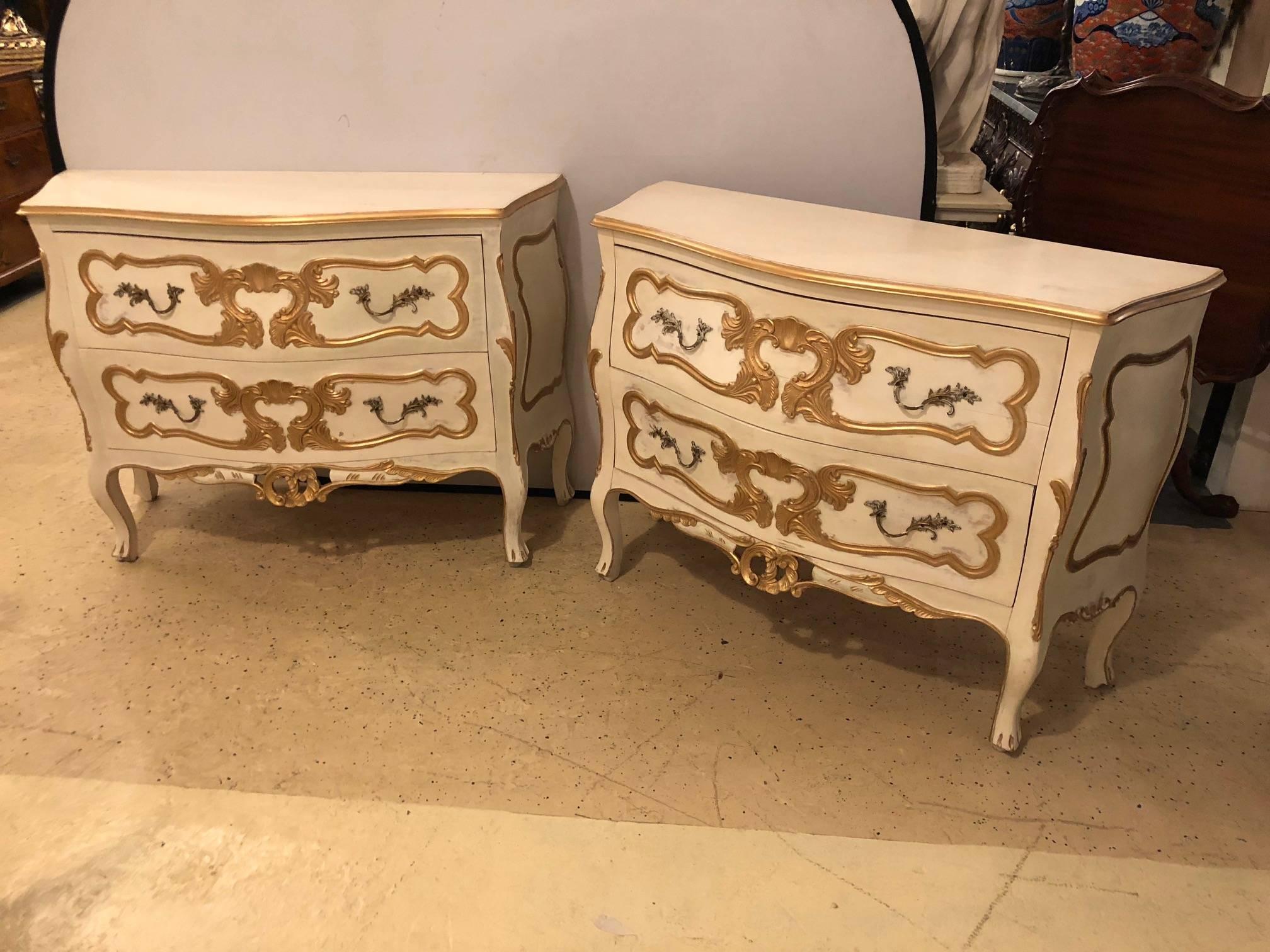 A very fine antique pair of bombe commodes or nightstands having a parcel paint and gilt decorated finish. These Italian delights are sure to make any room sparkle. The heavy gilt overlay on these Louis XV style commodes with bombe sides are certain