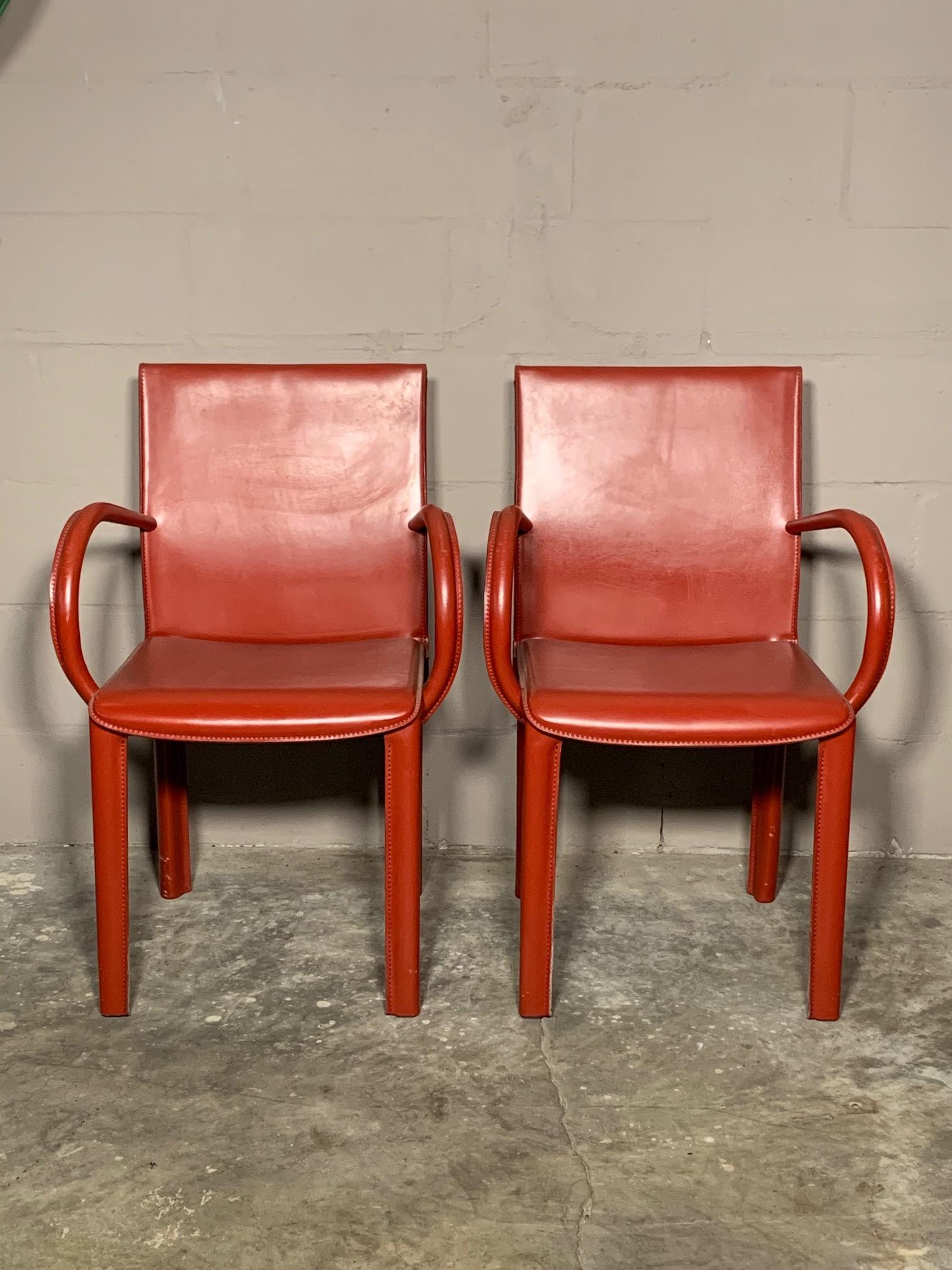 A pair of interesting leather armchairs by Arper, Italy, circa 1980s. Heavy and well made, in the style of Adnet. The color is burgundy.