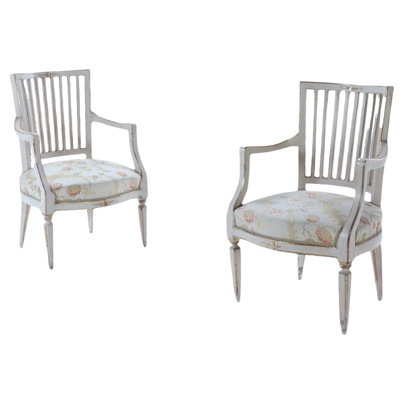 A Pair of Italian Directoire painted and gilt open arm chairs, C 1800.