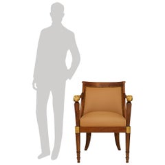 A pair of Italian early 19th century Neo-Classical st. Walnut and Giltwood armch