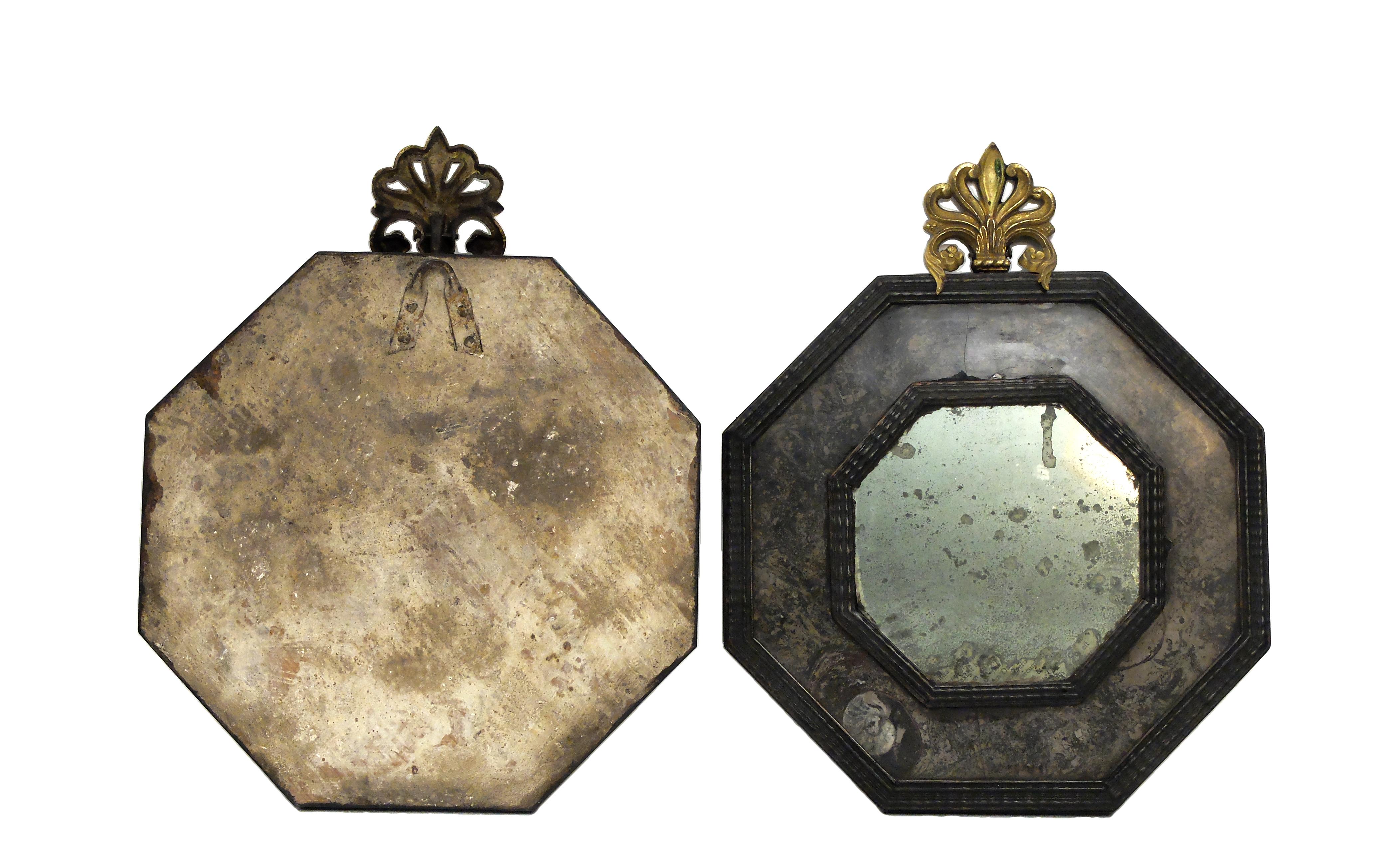 A pair of Wunderkammer mirrors with black fruit wood octagonal shape frames with hard stone covering (Lumachella stone). Gilded brass frieze.