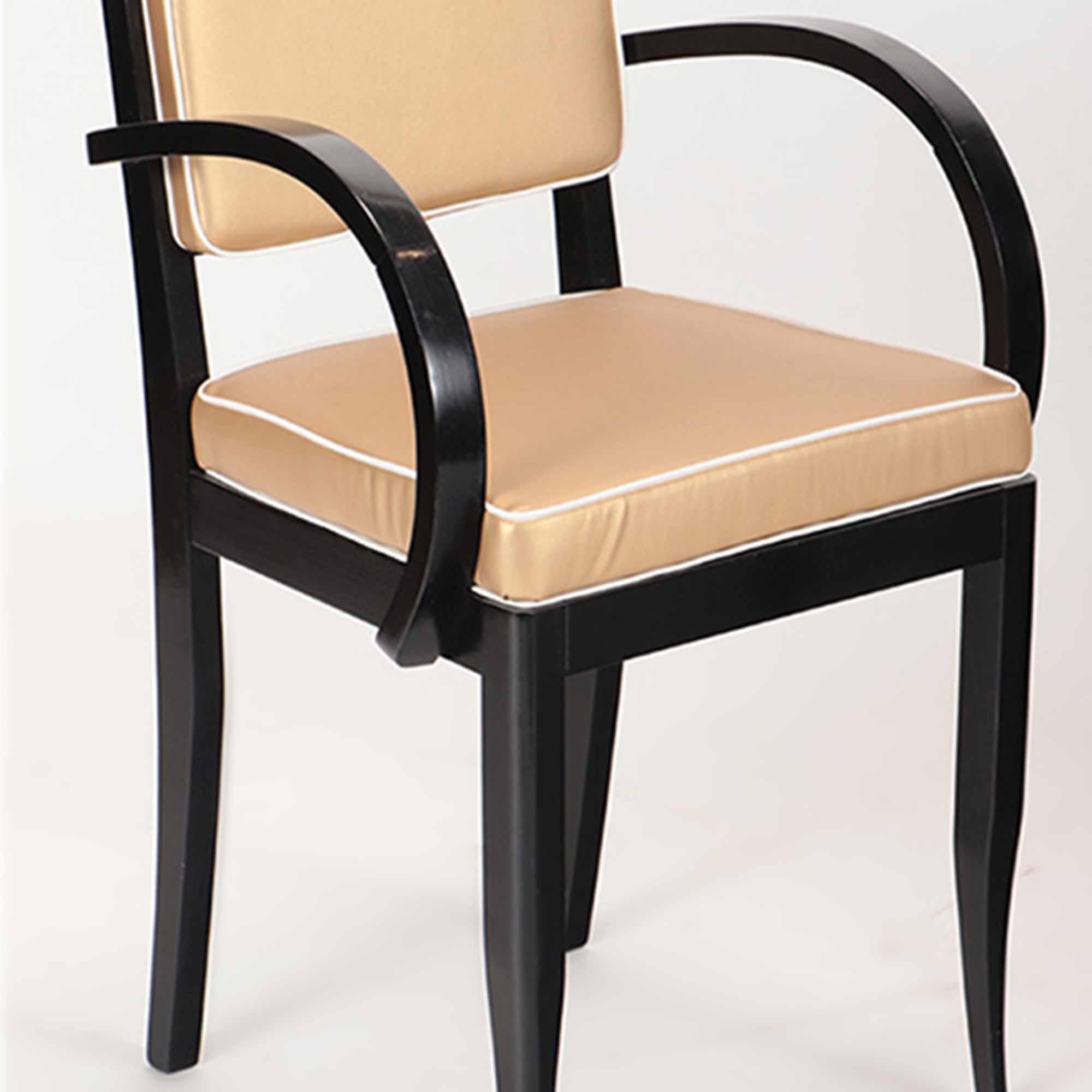 A Pair of Italian ebonized open armchairs with open armrests, circa 1940.