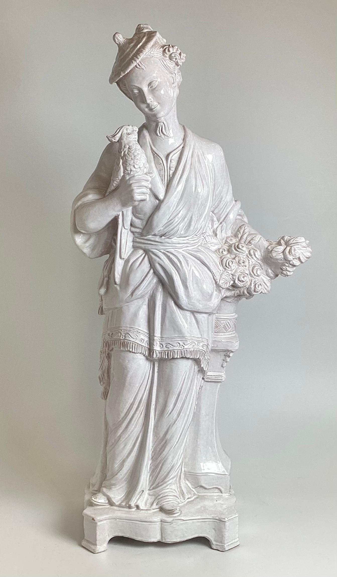 A stunning pair of mid 20th century tin glazed earthenware male and female chinoiserie figures. The man playing his string instrument, the woman with gathered flowers, each stands 36 inches tall weighing about 34-40 pounds each.  Bothe signed Italy