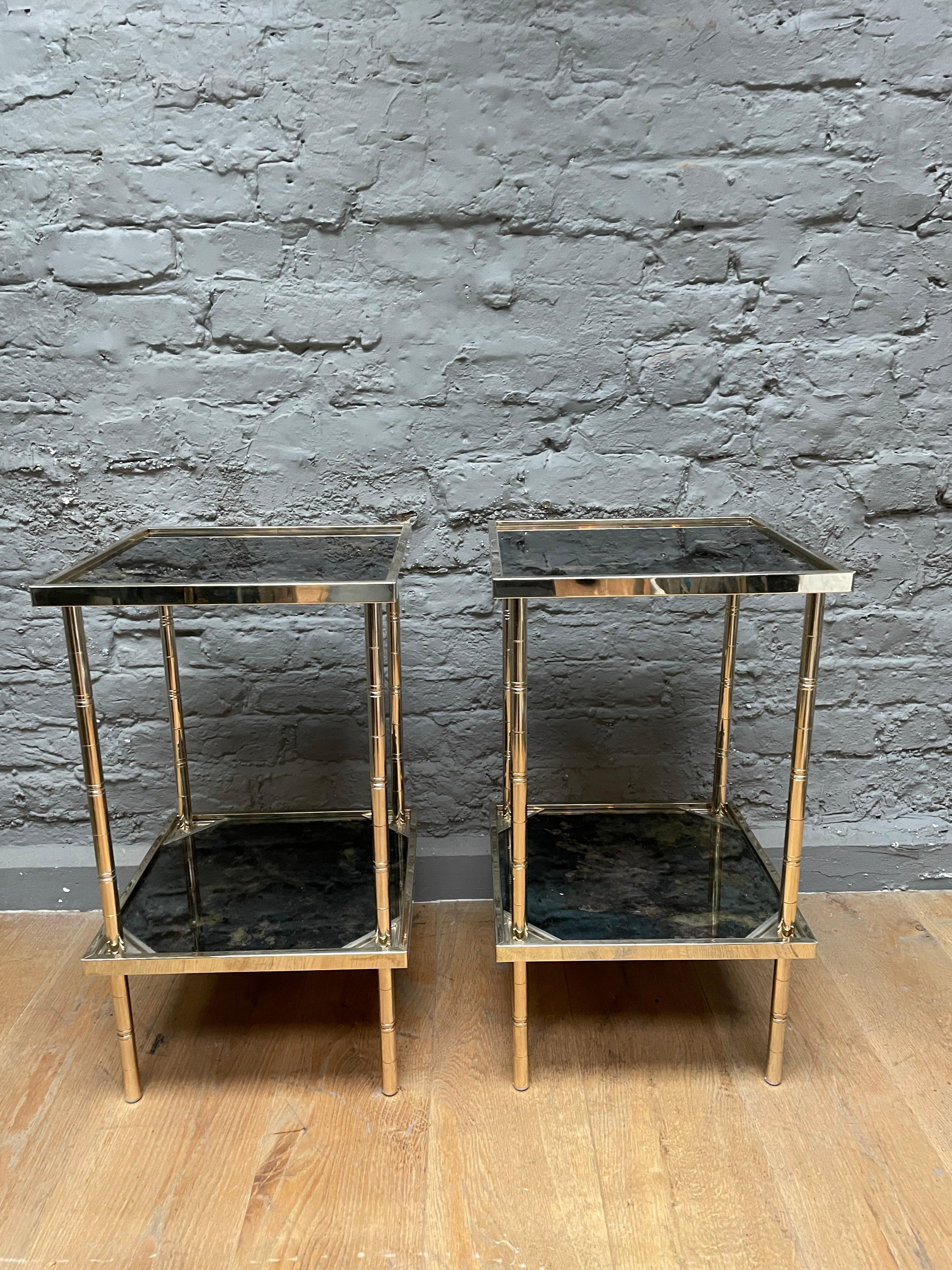 A pair of brass lacquered faux bamboo side tables with vere eglomise style tops.

Stamped on undersides Italy 1977.