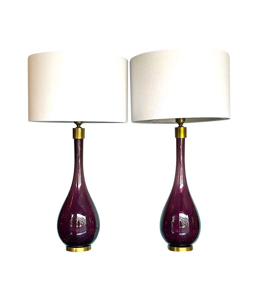 A pair of Italian large purple Murano glass teardrop shaped lamps mounted on brass bases with brass collar detail. Rewired with new brass fittings, antique purple cord flexes and PAT tested.