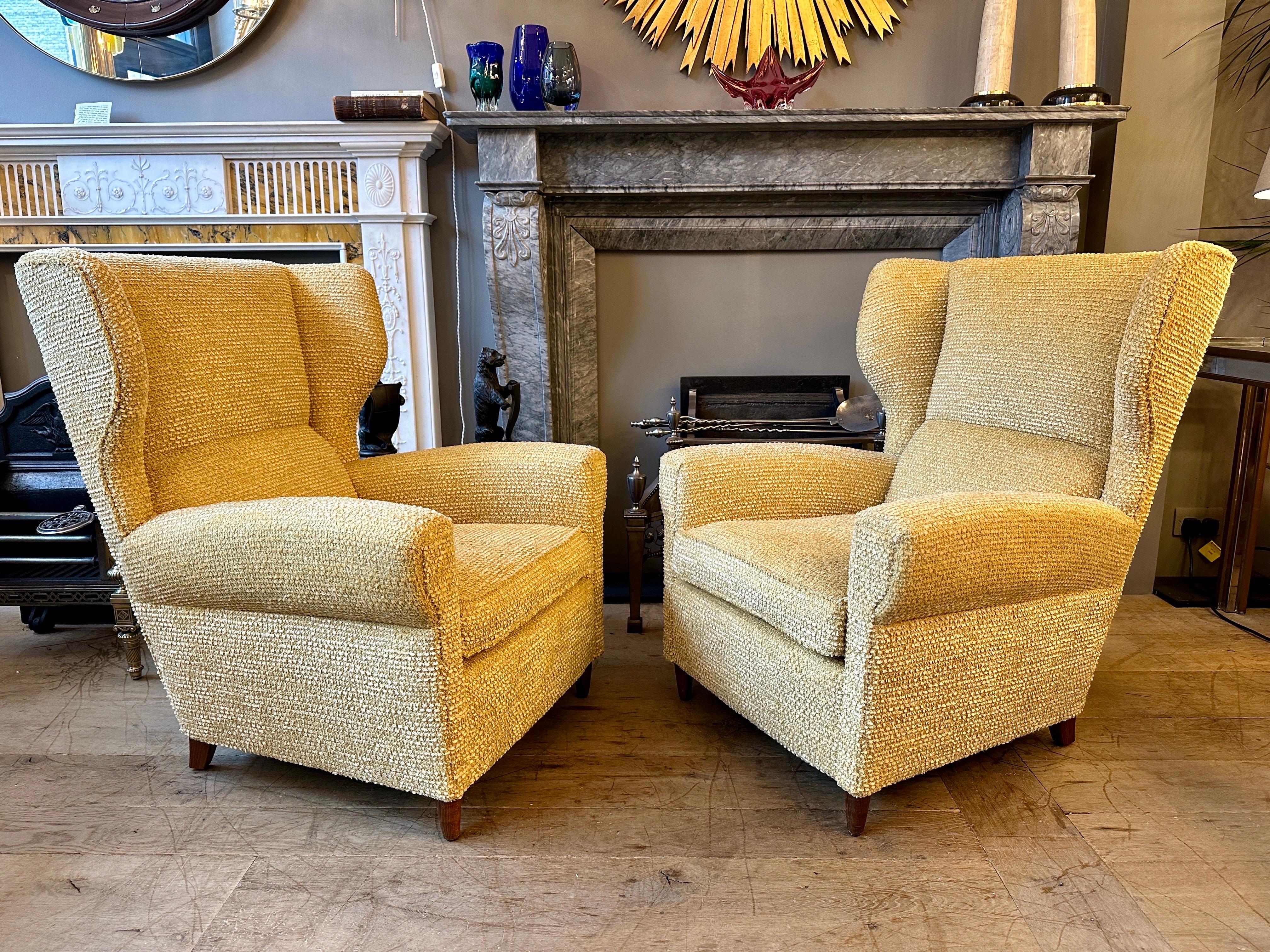 A pair of large re upholstered wing backed armchairs by Paolo Buffa Italy.

Images of these chairs in the catalogue on the slider. 1940-1950, wooden structure. Fully re upholstered in Osbourne and Little Boucle fabric. 

The chairs with wide curved