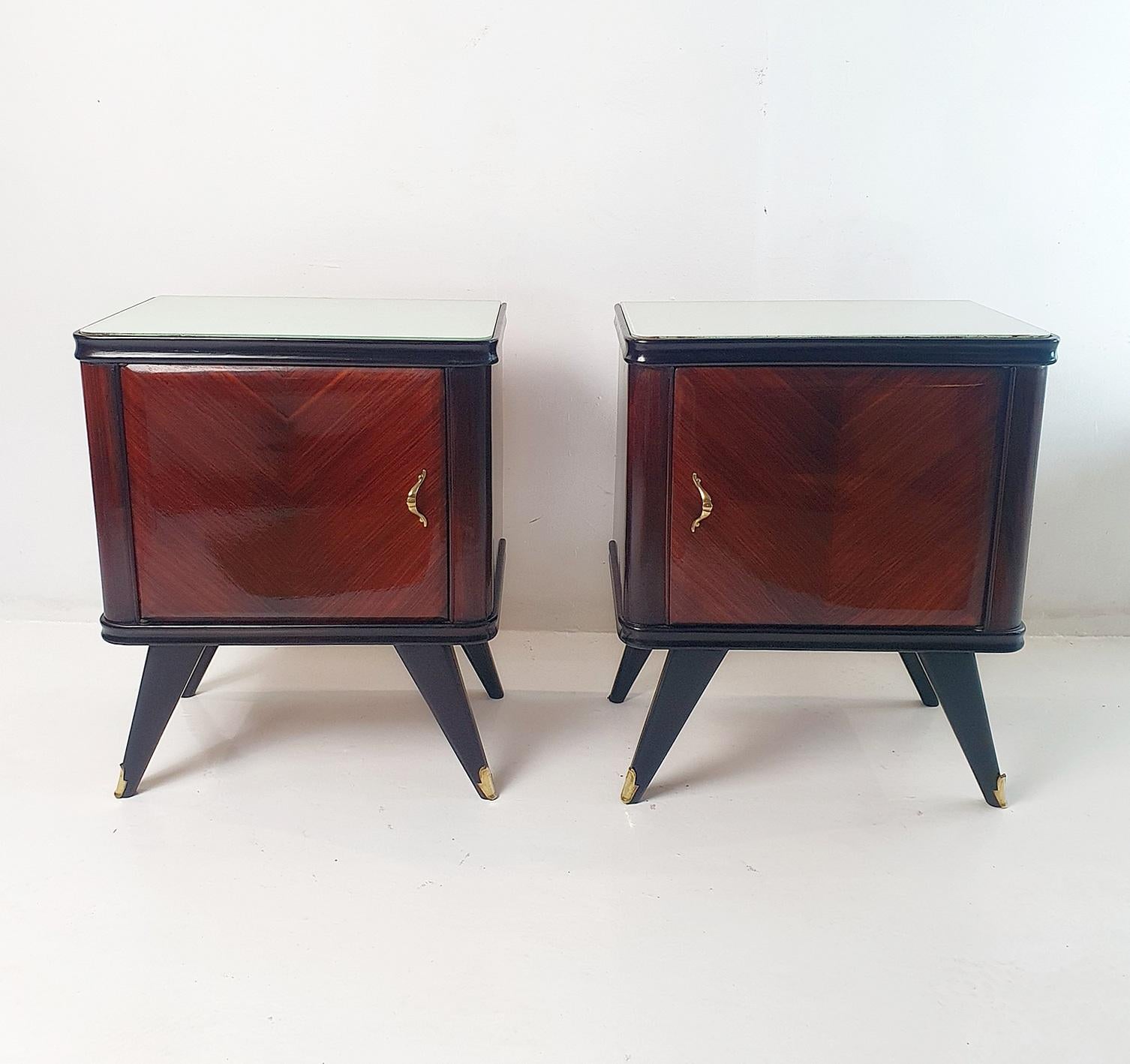 A pair of mid century modern nightstands handmade in Italy during the 1950's. The nightstands have been recently professionally restored with french polish giving the wood a beautiful shine reflecting the grain in the wood. Topped with a single