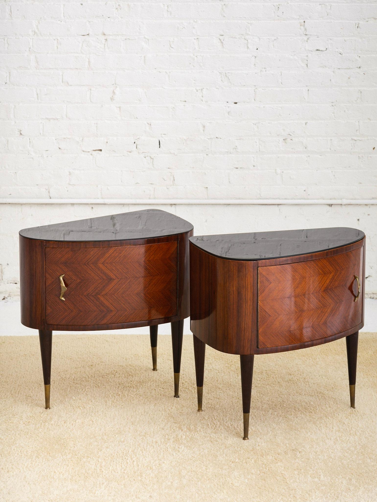 A pair of mid century nightstands in the style of Paolo Buffa. Wood inlay creates a parquet pattern across the front. Rounded front gives a 