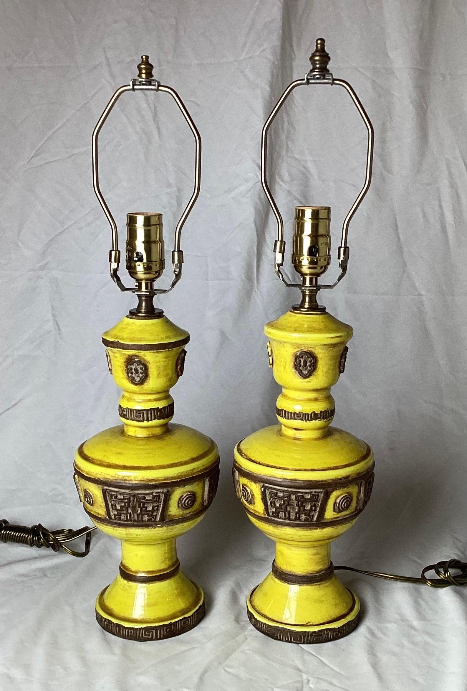 A stylish pair of Italian hand thrown pottery lamps with yellow glaze. The lamps with dark brown details with the Zaccagnini logo at the bottoms, 20 tall to the top of the harp, 11.5 to the top of the pottery.