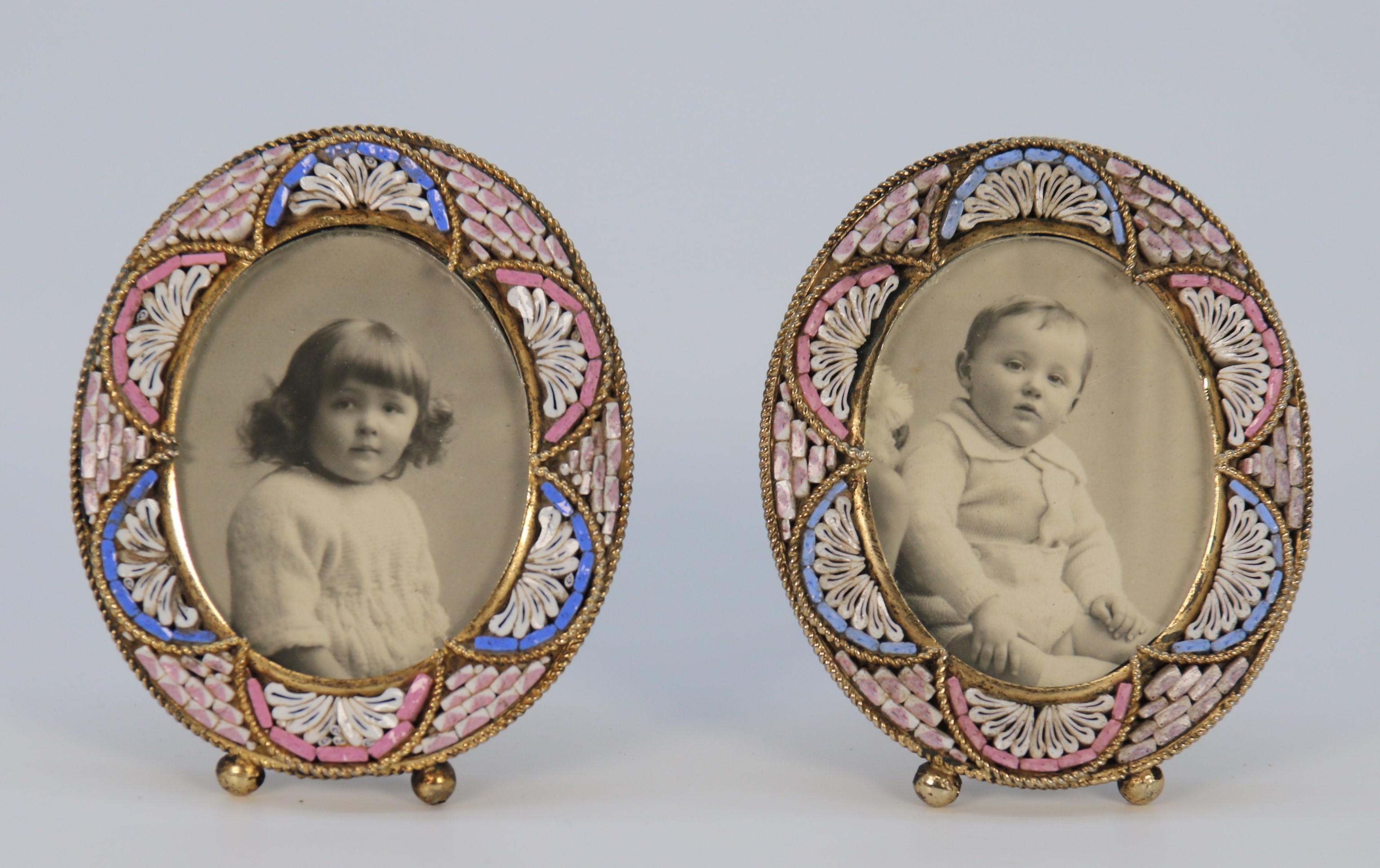This rare pair of Italian miniature micro mosaic photo frames is made from brass. They have original hinged easel stands and removable back panels with oval glasses.

These beautiful pieces are decorated with pastel coloured cut glass fragments
