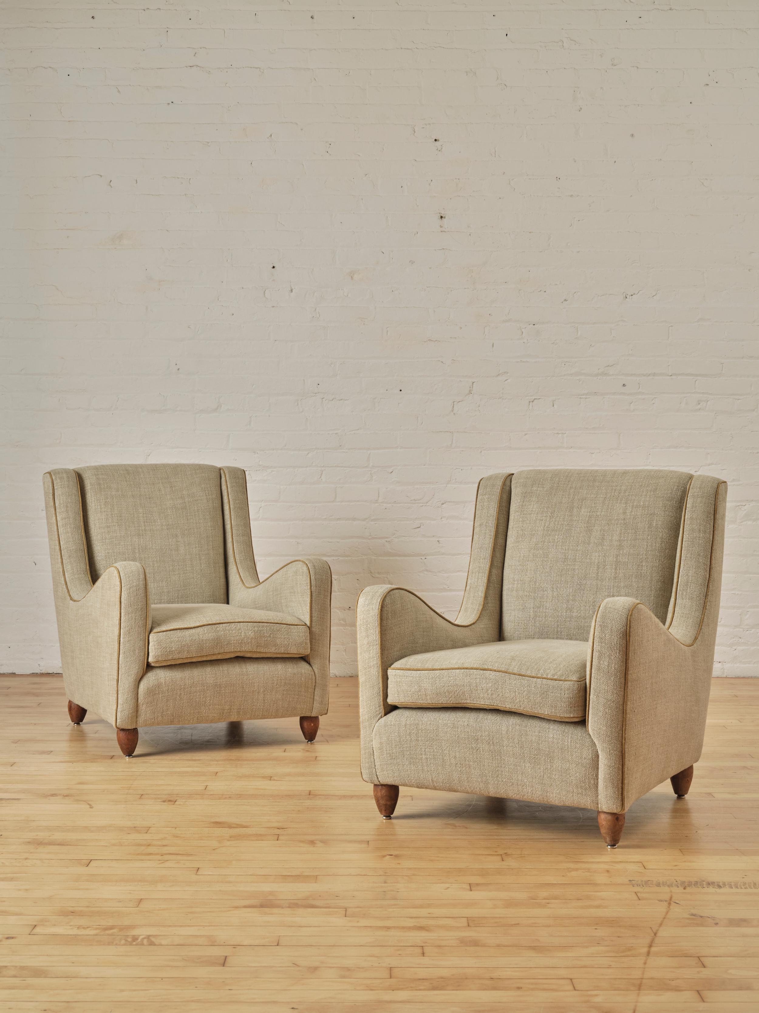 A Pair of Italian Modern Lounge Chairs in the Manner of Gio Ponti reupholstered in a oatmeal heavy Linen and Cotton fabric with yellow piping. 

