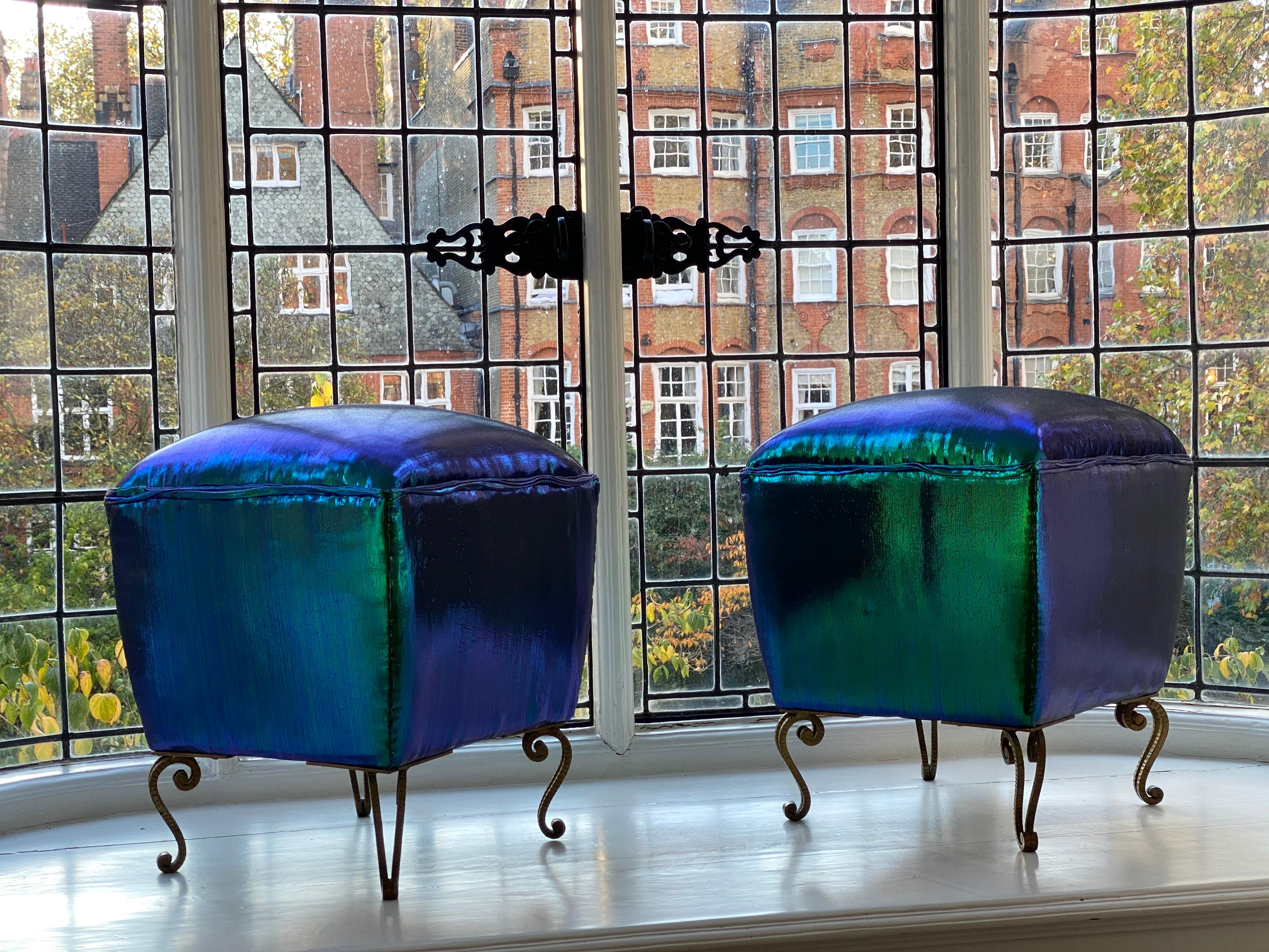 A pair of Italian stools by Pier Luigi Colli, reimagined by Studio Bucchi in iridescent fabric supported on gilt and hammered legs.