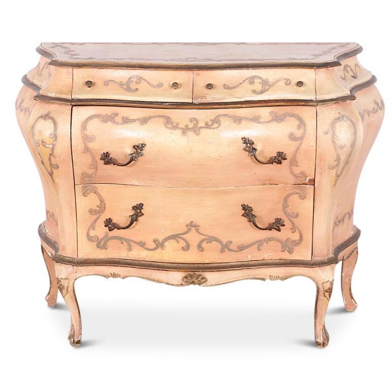 Unusual to find in a pair- vintage painted bombe commodes from Italy. The painted finish is showing attractive age-related patina and fading and is accented with raised scrolled details.
    