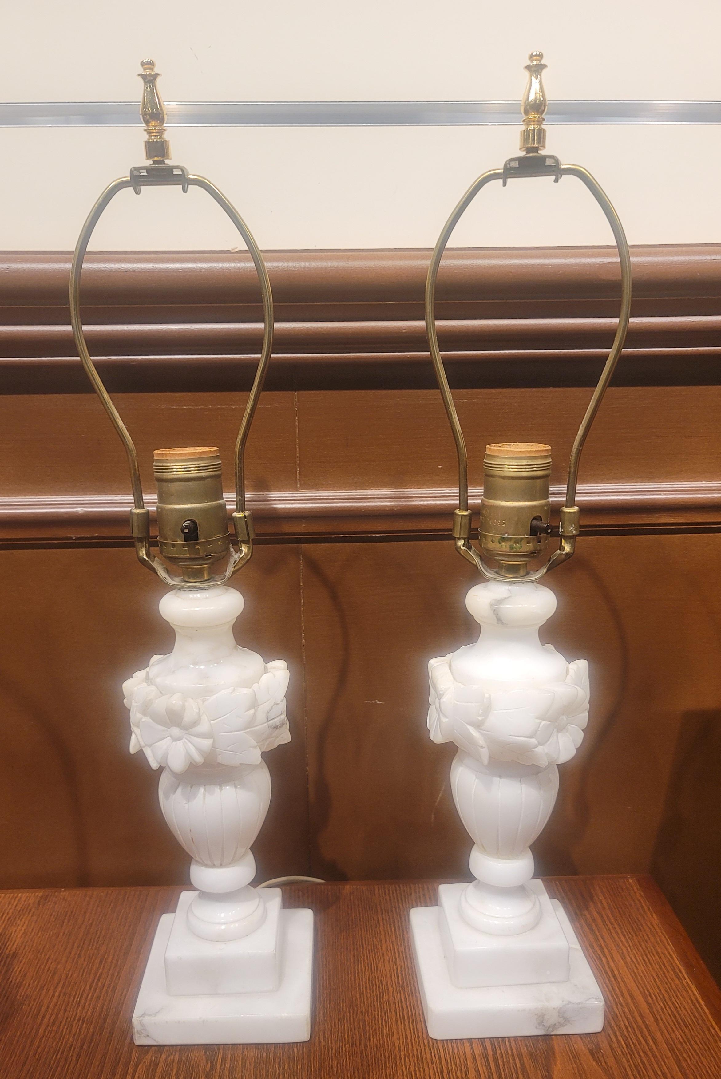 Pair of white Italian Marble lamp in great condition. Measure 3.5 inches in width at the base, 3.5 inches in depth and stands 18.75 inches to the top of the finials.